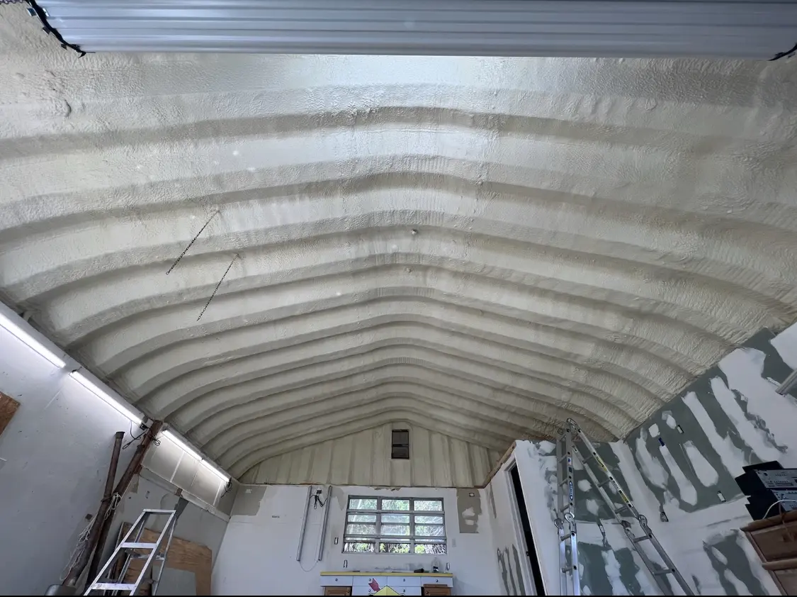 Spray polyurethane foam applied to the underside of a metal roof deck in Altus